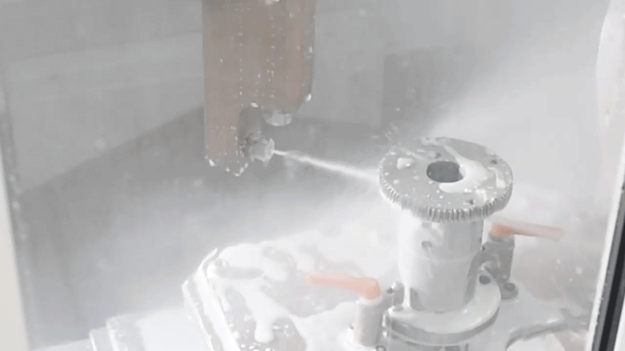 Sugino's water jet deburring machine in motion and actively removing burrs